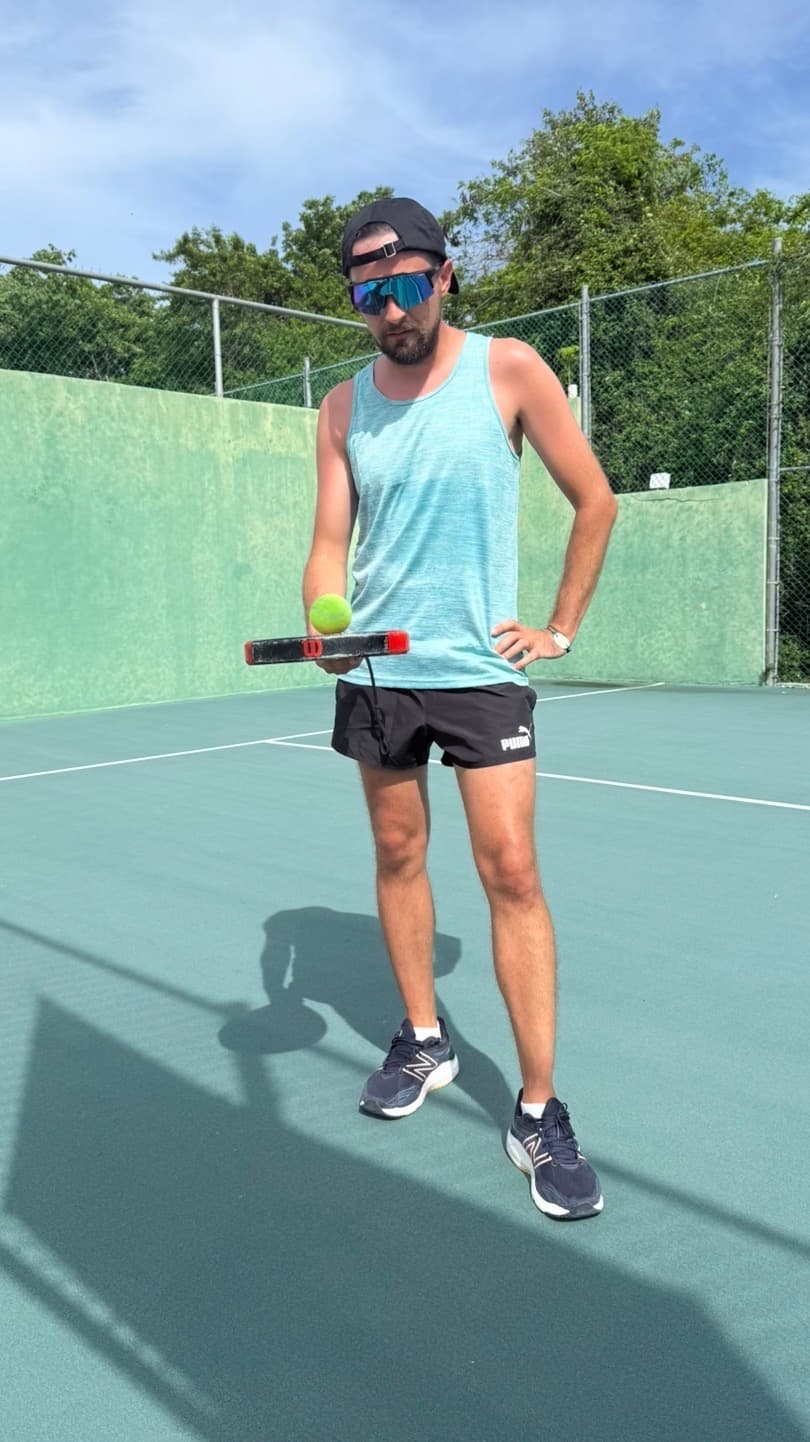 Roman Moroz holding a padel racket on court.